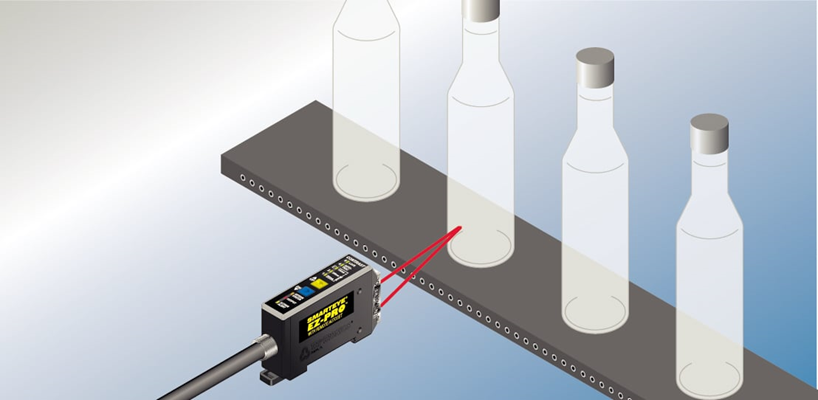 Diffuse optical sensor detecting bottles on a conveyor
